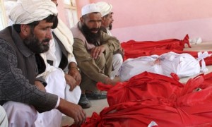 Afghan relatives surround the bodies in Andar