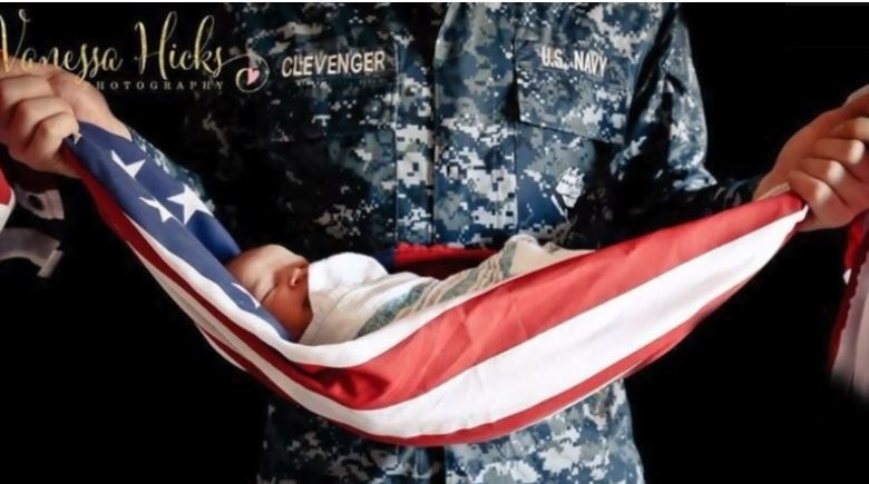 baby in flag cradle